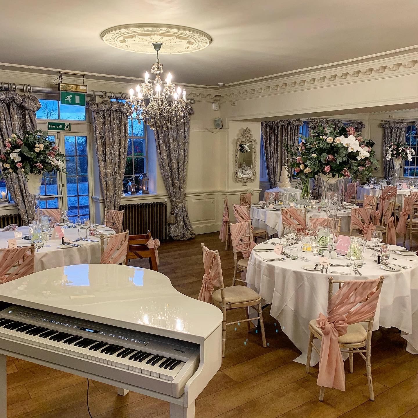 Eaves Hall wedding pianist Craig Smith plays his white piano in the Ballroom