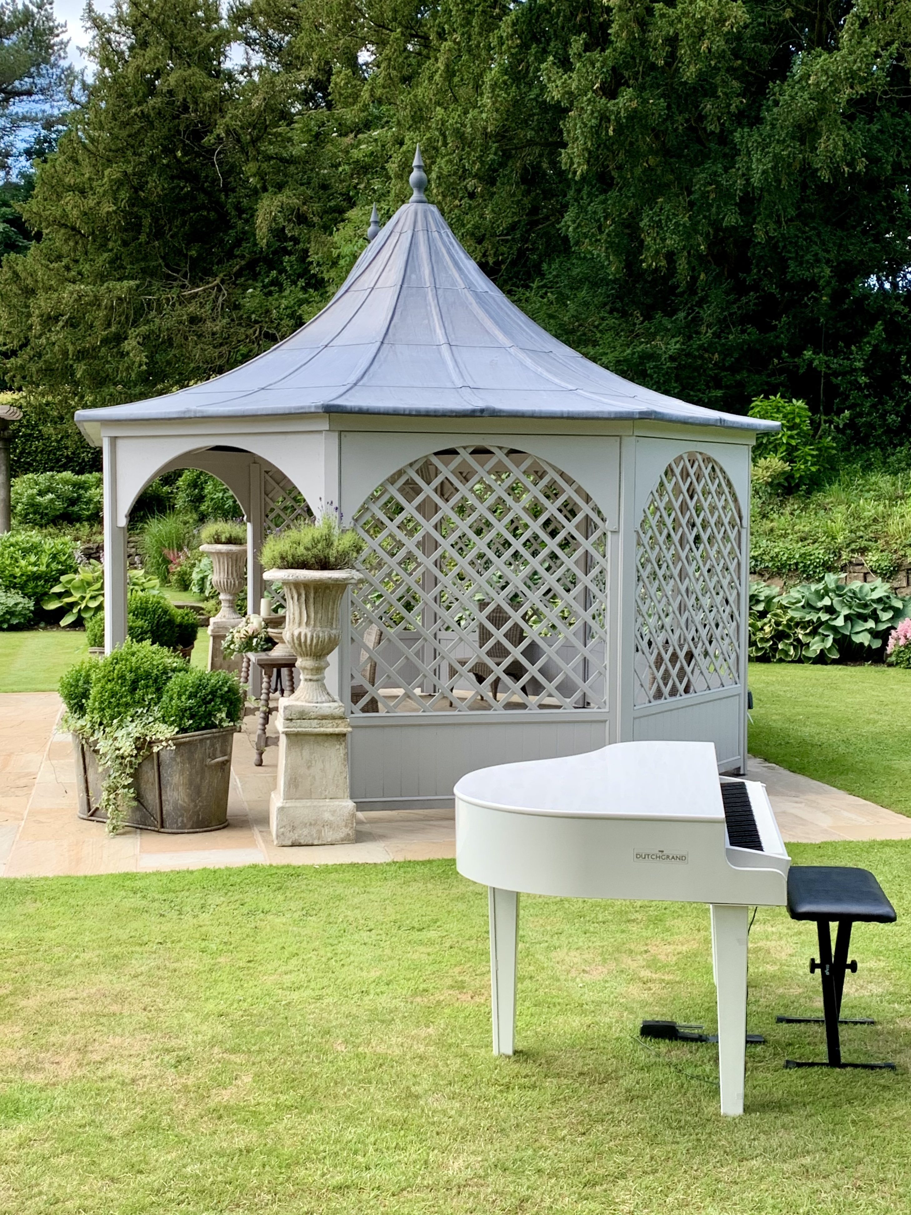 Eaves Hall wedding pianist Craig Smith's white piano set up ready for an outdoor ceremony at the Wedding Pavilion