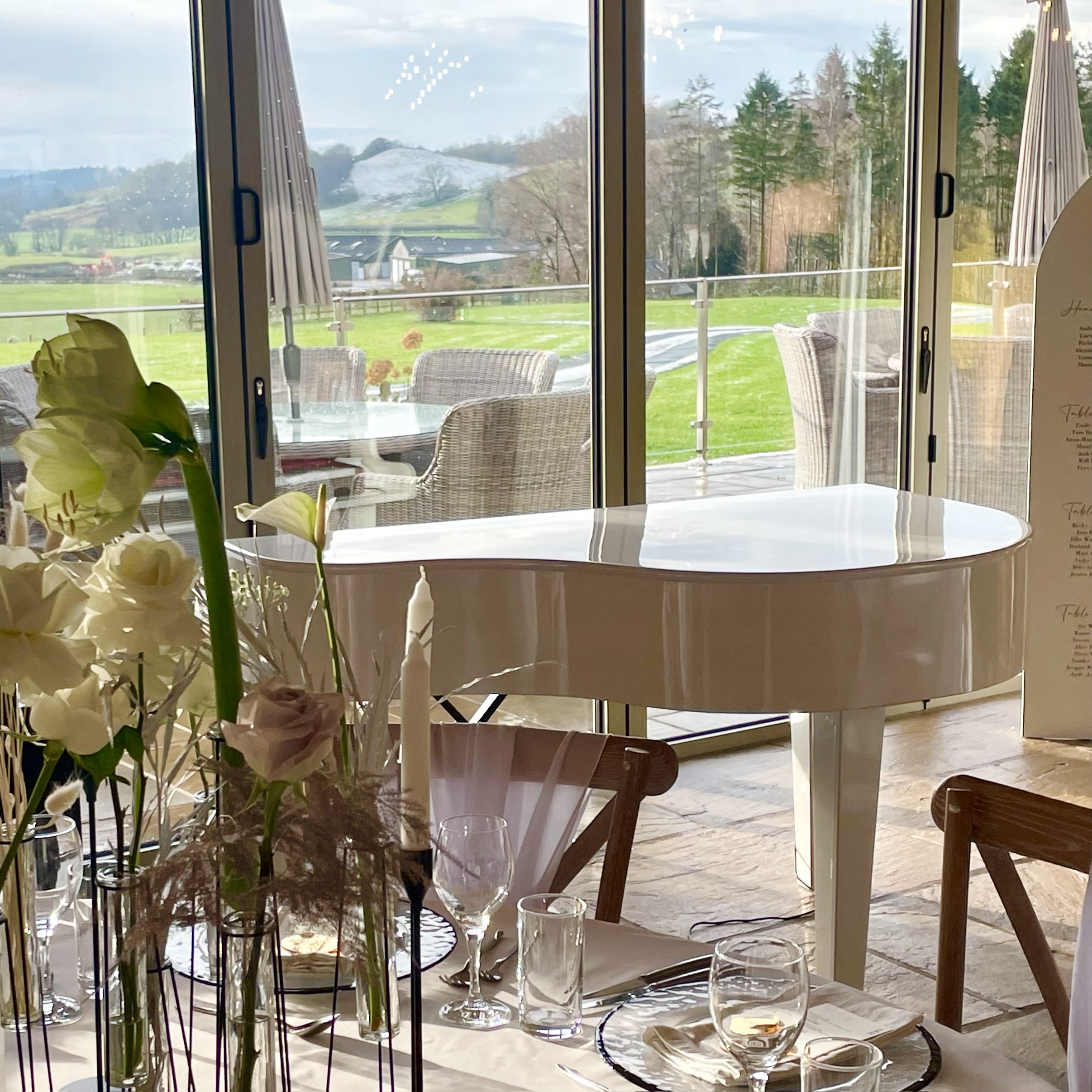 Hobbit Hill wedding pianist Craig Smith plays a white baby grand piano for a wedding breakfast at the venue