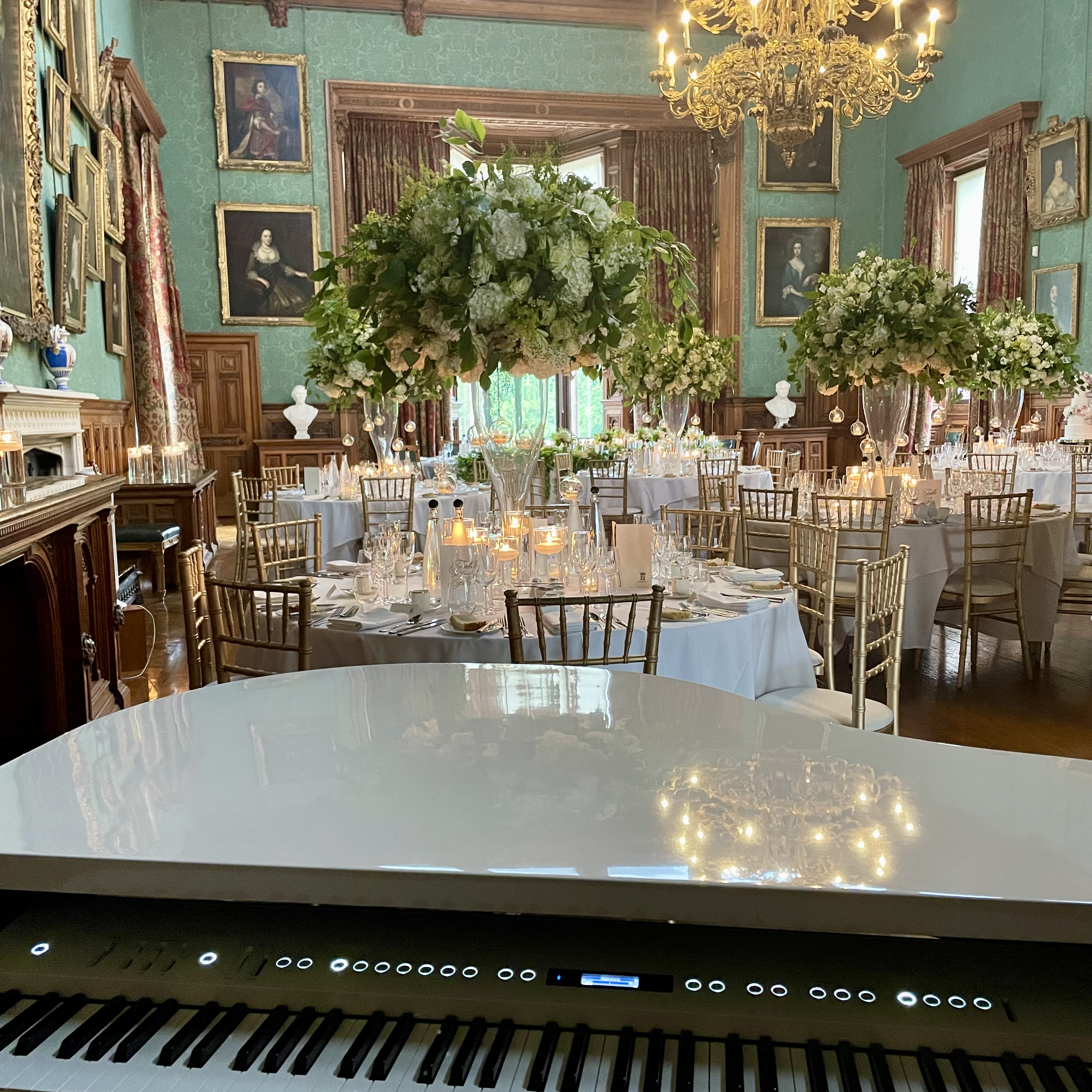 Wedding pianist Craig Smith's white baby grand in the Knowsley Hall State Dining Room ahead of a wedding breakfast