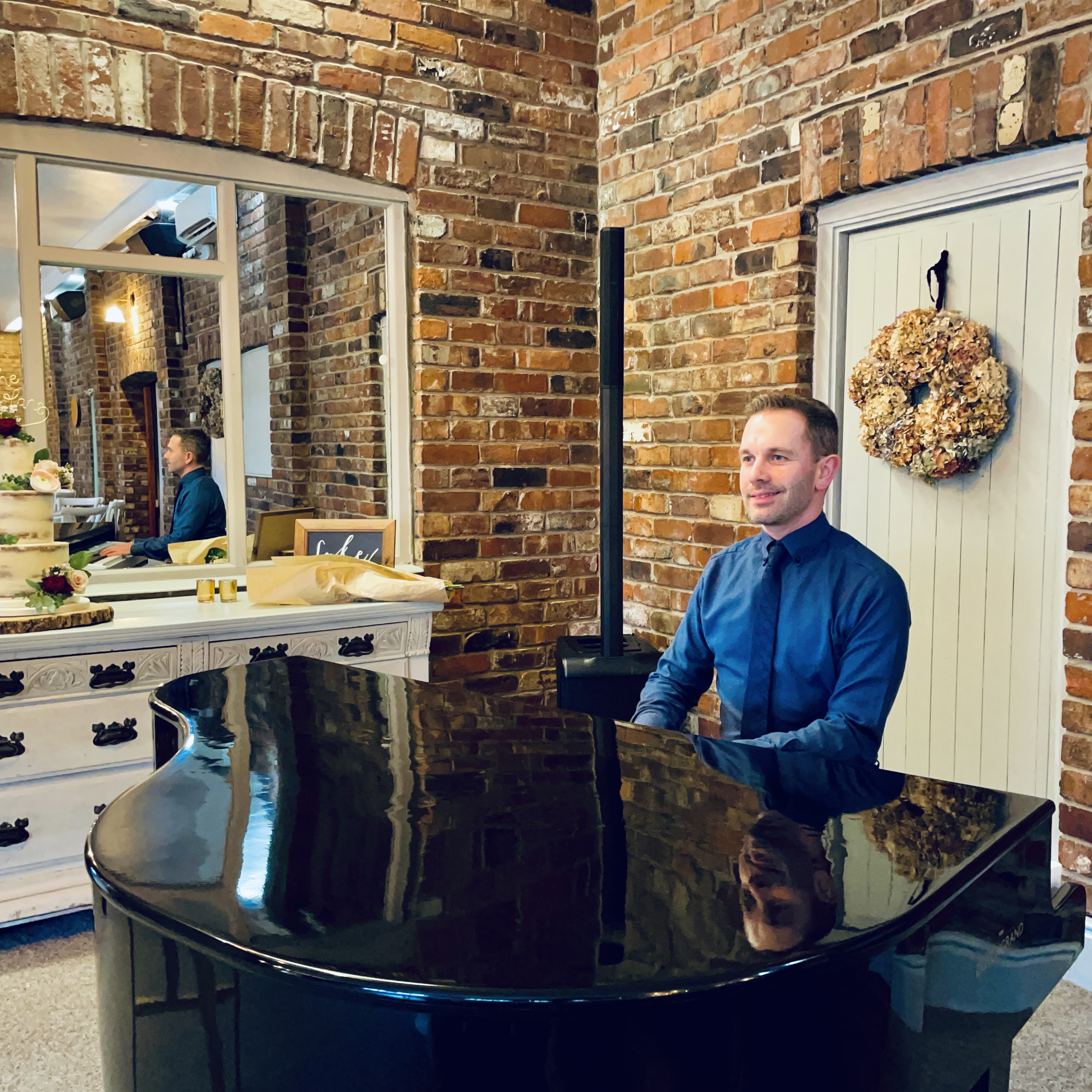 Wedding pianist Craig Smith performs during a Larkspur Lodge wedding breakfast on his black baby grand piano