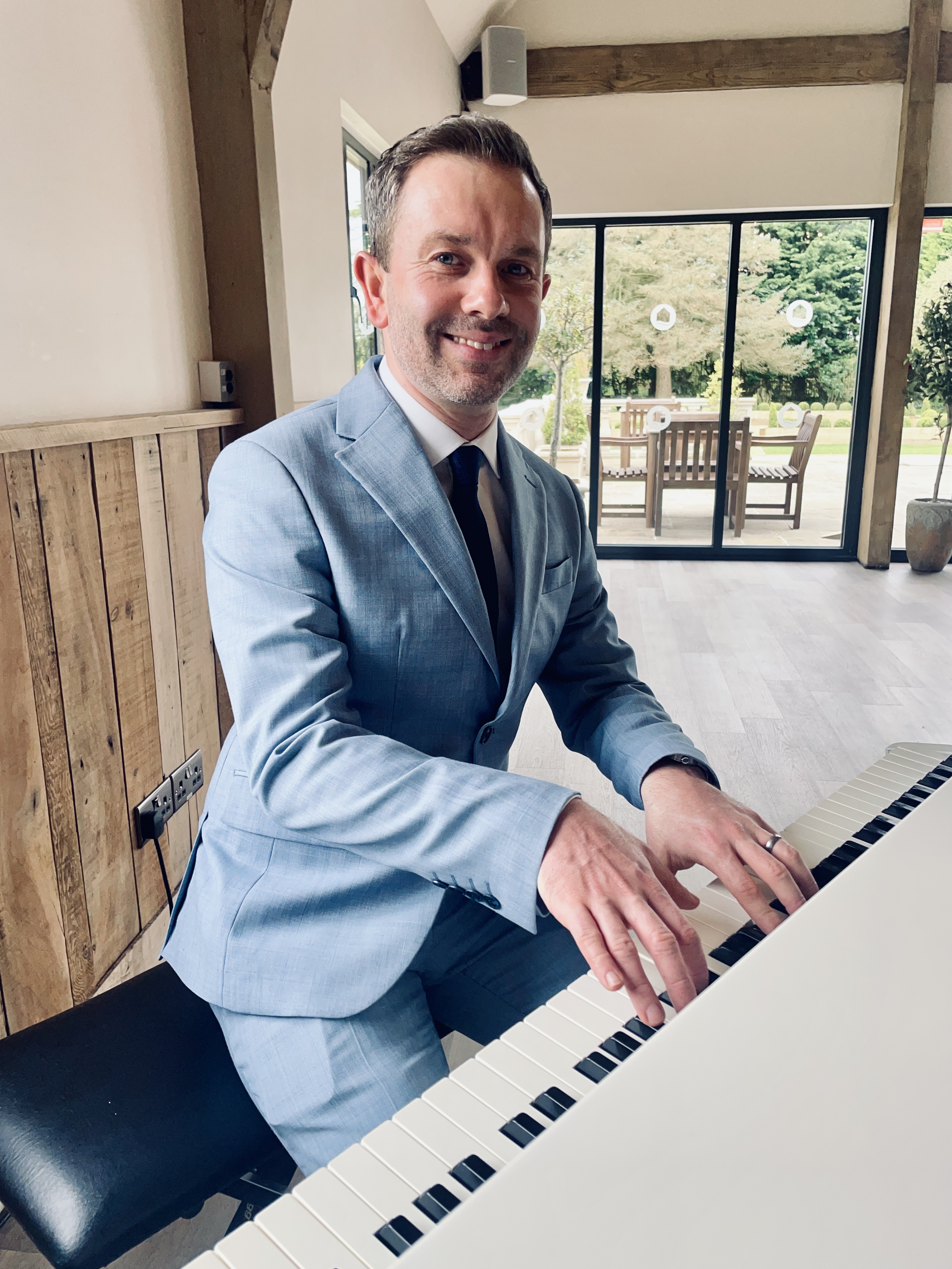 Craig Smith playing piano during River Barn wedding reception