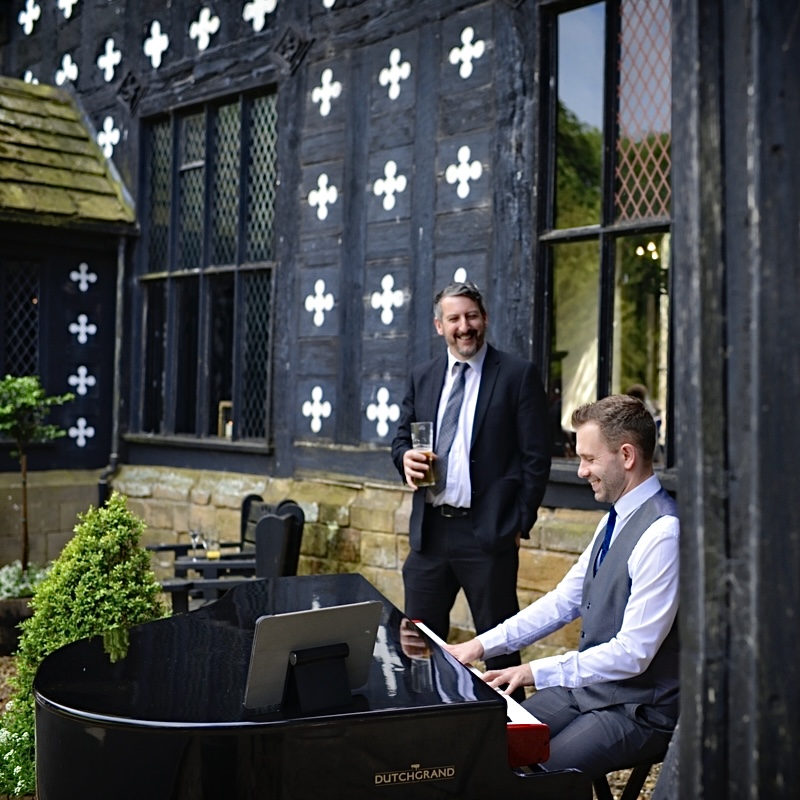Live Samlesbury Hall drinks reception music by wedding pianist Craig Smith, outside in front of the Tudor hall