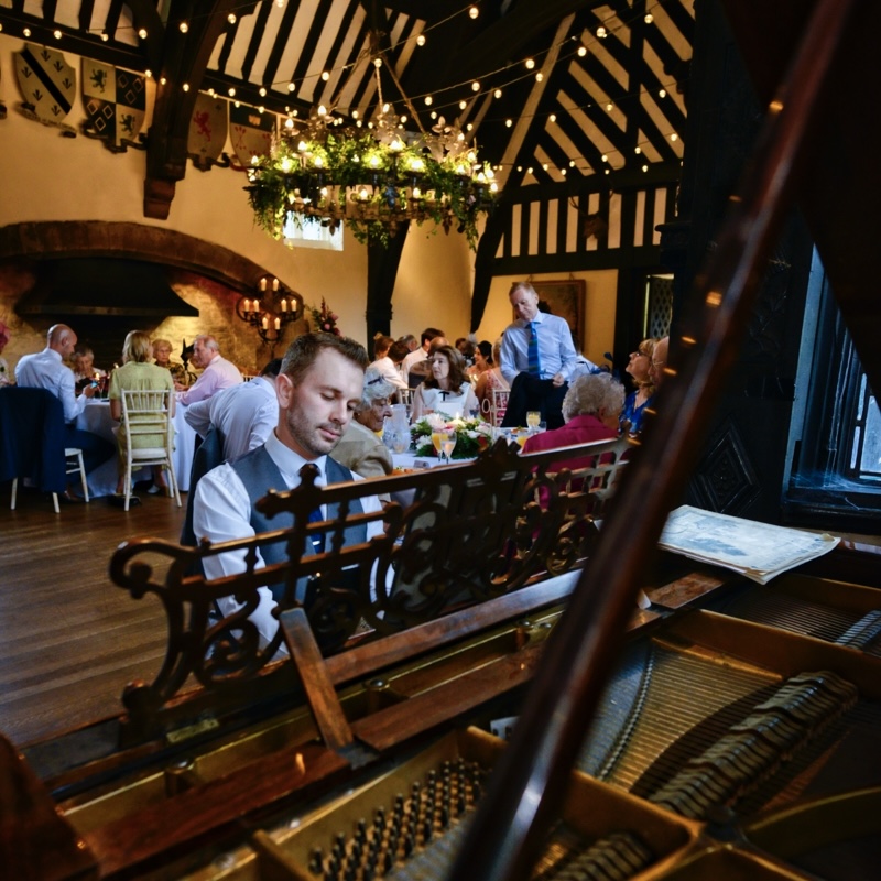 Wedding pianist Craig Smith plays Samlesbury Hall's grand piano during a wedding breakfast